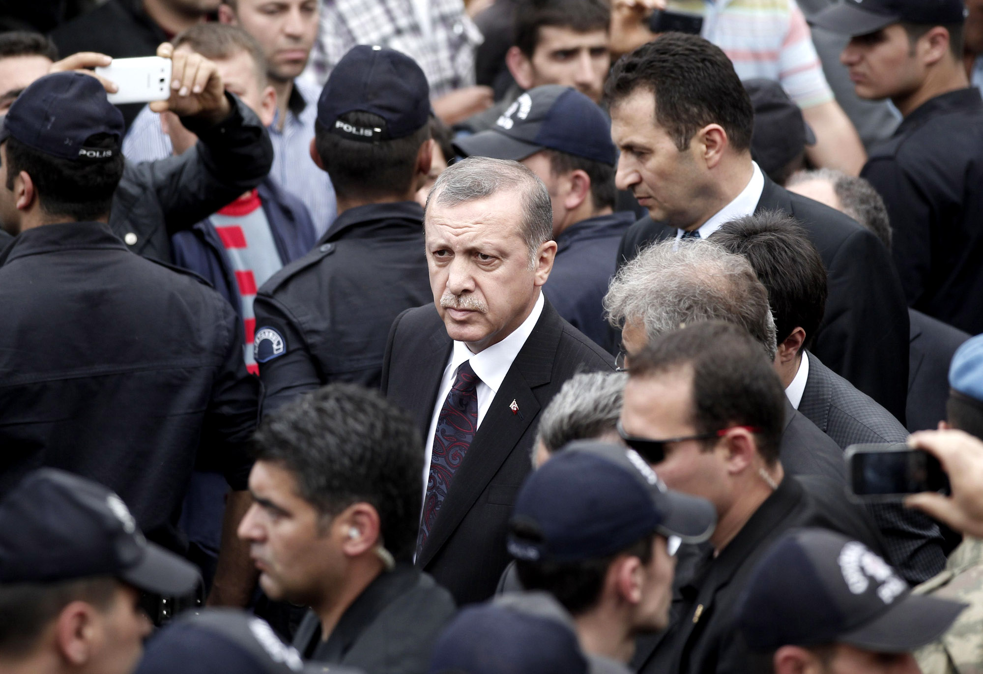 Turkey's Prime Minister Erdogan walks during his visit to Soma, a district in Turkey's western province of Manisa, after a coal mine explosion