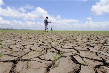 A Brazilian crosses the muddy bottom of the Rio Negro